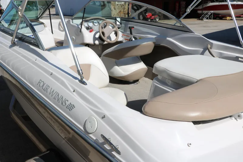 Slide: The Image of 2006 Four Winns 180 Horizon boat interior with beige and white seating. - 6