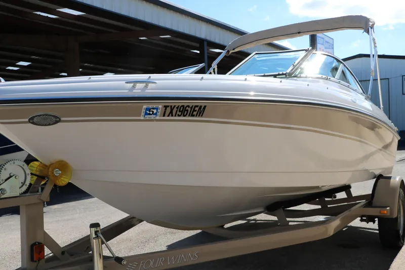 Slide: The Image of 2006 Four Winns 180 Horizon boat on trailer, parked outdoors. - 7
