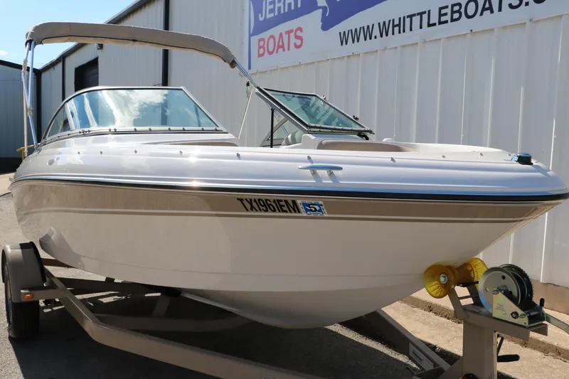 Slide: The Image of 2006 Four Winns 180 Horizon boat on trailer, parked outside a boat dealership. - 8