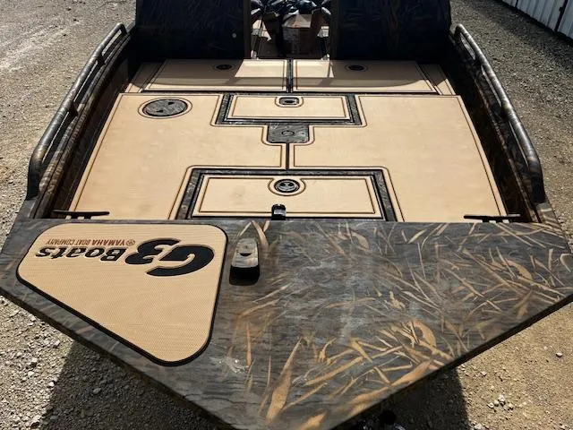 Slide: The Image of 2025 G3 Sportsman 2400 boat deck with camouflage design and storage compartments. - 10