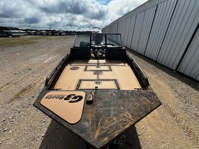 Slide: The Image of 2025 G3 Sportsman 2400 boat, parked outdoors, showcasing deck and windshield. - 11