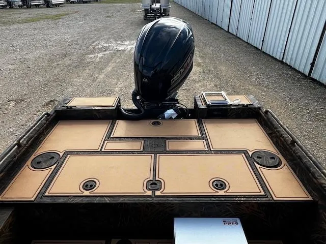 Slide: The Image of 2025 G3 Sportsman 2400 boat with motor, storage compartments, and fishing rod holders. - 12