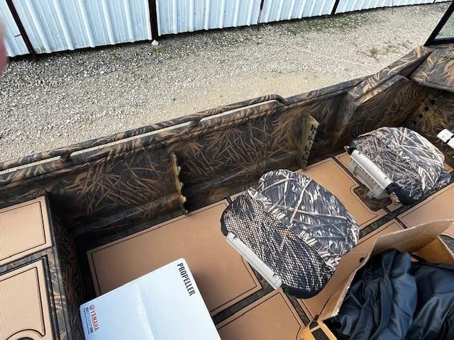 Slide: The Image of 2025 G3 Sportsman 2400 boat interior with camouflage seats and Yamaha propeller box. - 13