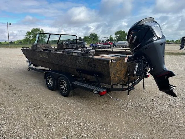Slide: The Image of 2025 G3 Sportsman 2400 boat on trailer with outboard motor, parked on gravel. - 5