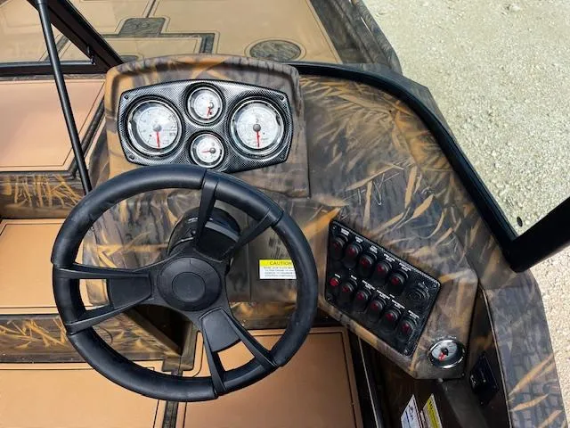 Slide: The Image of Steering console of 2025 G3 Sportsman 2400 boat with gauges and controls. - 8