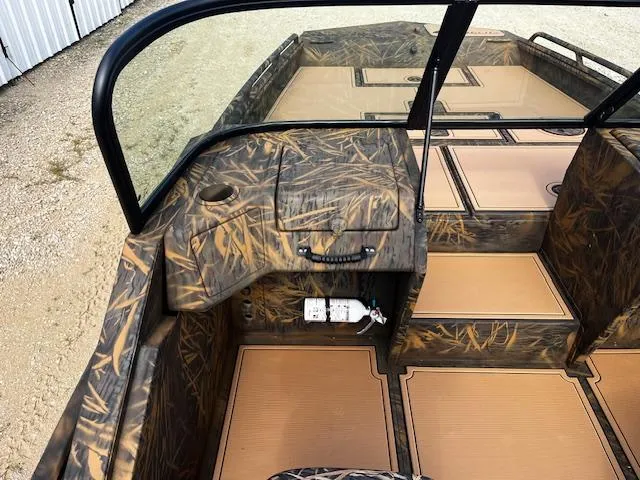 Slide: The Image of 2025 G3 Sportsman 2400 boat interior with camouflage design and tan flooring. - 9