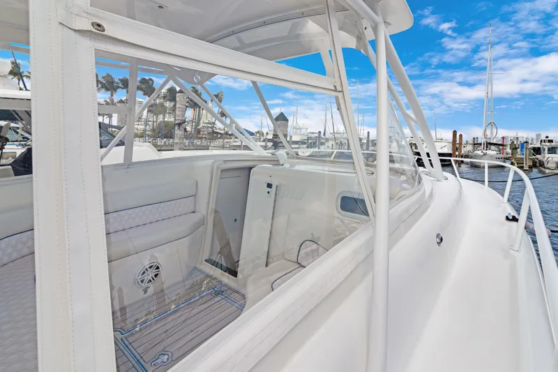 Slide: The Image of 2004 Intrepid 377 Walkaround boat docked at marina under clear blue sky. - 20