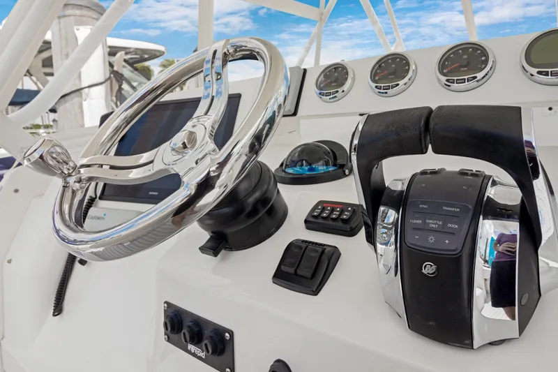 Slide: The Image of Control panel of a 2004 Intrepid 377 Walkaround boat with steering wheel and gauges. - 3