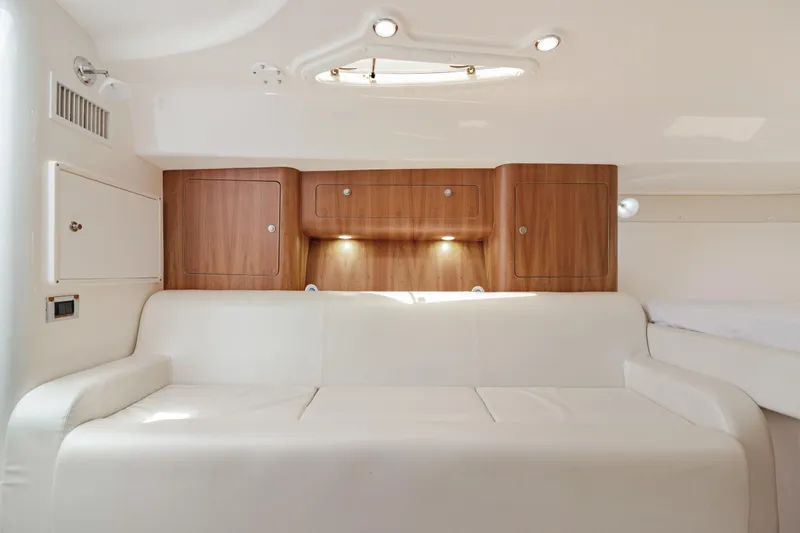 Slide: The Image of 2004 Intrepid 377 Walkaround interior with white sofa and wooden cabinets. - 33