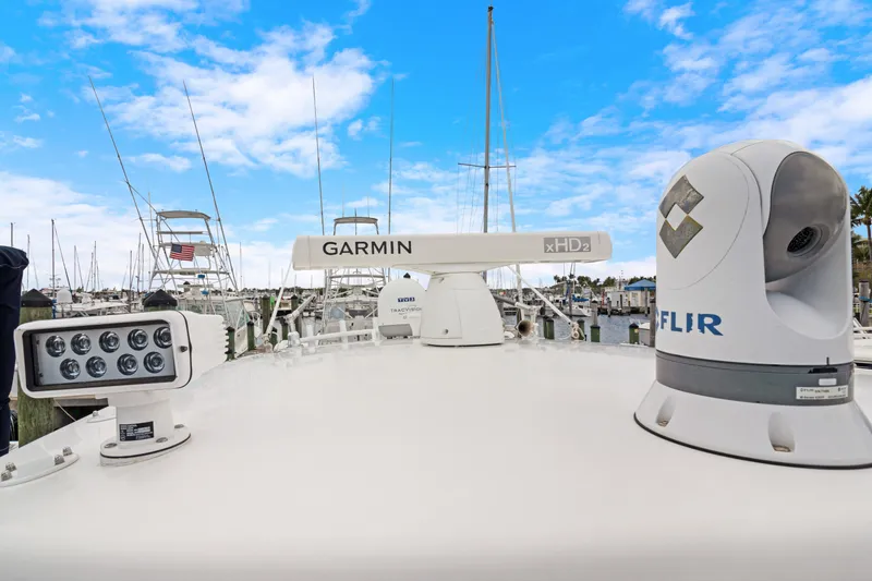 Slide: The Image of 2004 Intrepid 377 Walkaround boat with Garmin and FLIR equipment, docked under a blue sky. - 41