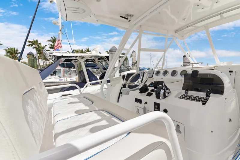 Slide: The Image of 2004 Intrepid 377 Walkaround boat interior with steering wheel and control panel. - 8