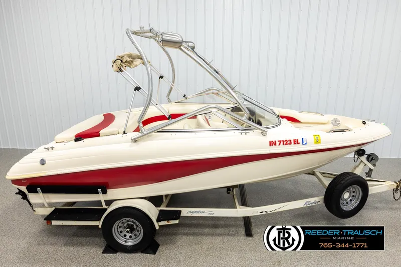 Slide: The Image of 2002 Rinker 192 Captiva boat on trailer, red and white design, indoor showroom. - 1