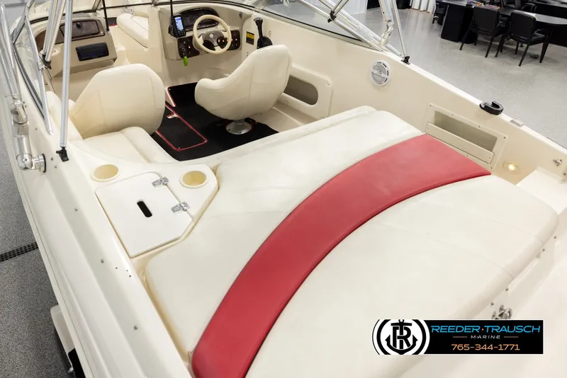 Slide: The Image of 2002 Rinker 192 Captiva boat interior with white and red seating, steering wheel, and controls. - 11