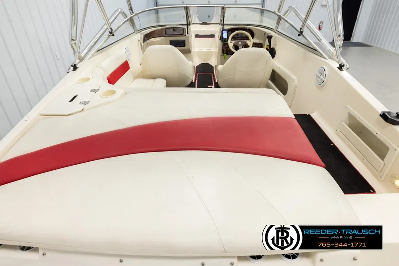 Slide: The Image of 2002 Rinker 192 Captiva boat interior with red and white seating, steering wheel, and dashboard. - 13