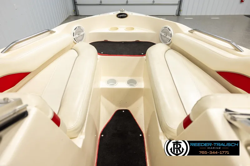 Slide: The Image of 2002 Rinker 192 Captiva boat interior with beige seating and red accents. - 15
