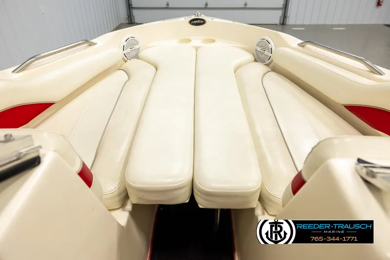 Slide: The Image of 2002 Rinker 192 Captiva boat interior with cream seating and red accents. - 16