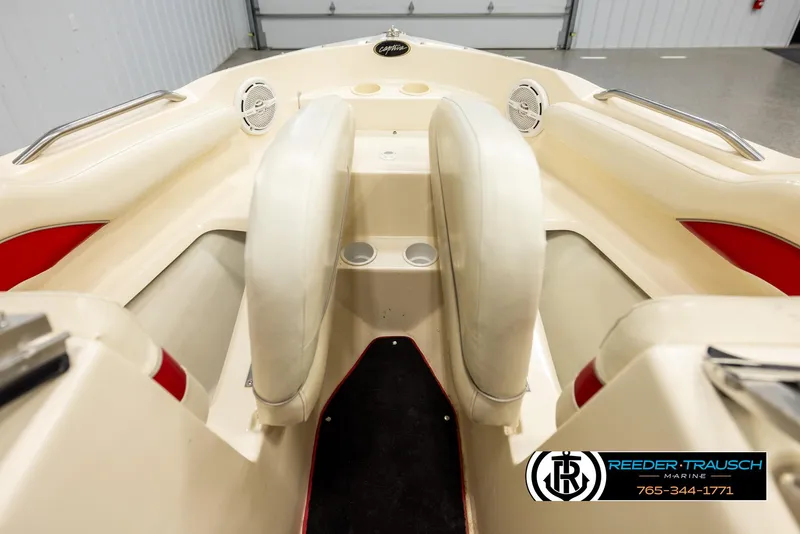 Slide: The Image of 2002 Rinker 192 Captiva boat interior with beige seating and cup holders. - 17