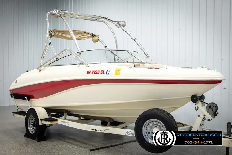 Slide: The Image of 2002 Rinker 192 Captiva boat on trailer in indoor showroom. - 2