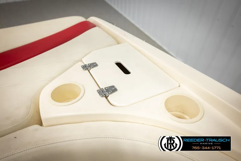 Slide: The Image of 2002 Rinker 192 Captiva boat interior with cup holders and storage compartment. - 24