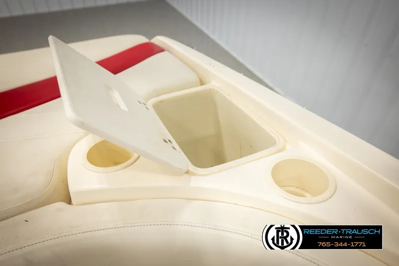Slide: The Image of 2002 Rinker 192 Captiva boat interior with storage compartment and cup holders. - 25