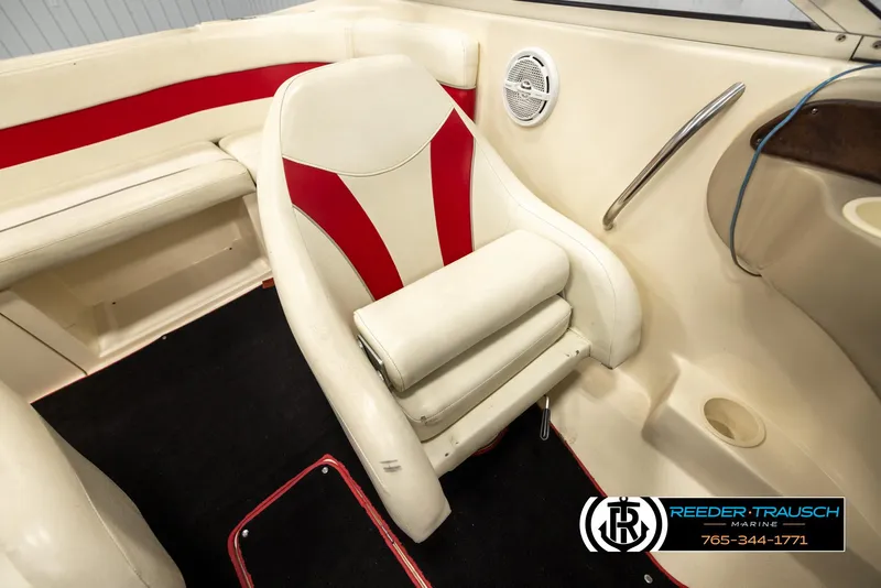 Slide: The Image of 2002 Rinker 192 Captiva boat interior with red and white seating and speaker. - 27