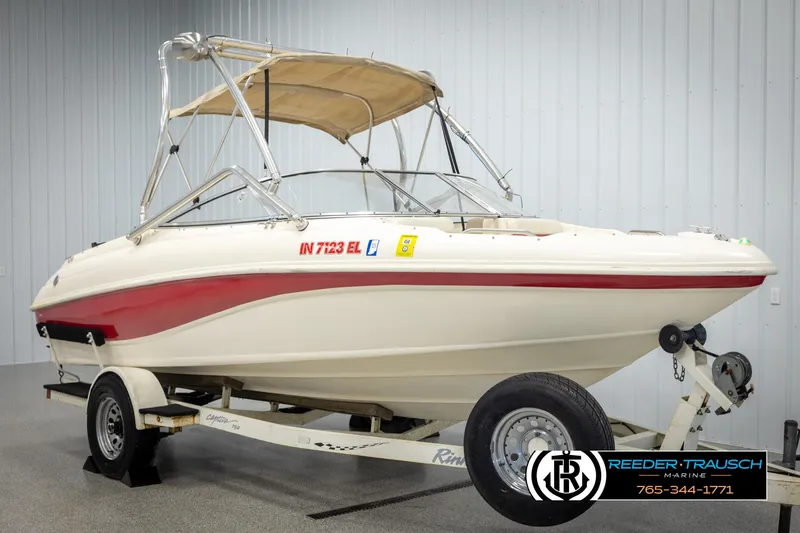 Slide: The Image of 2002 Rinker 192 Captiva boat on trailer with canopy in indoor setting. - 3