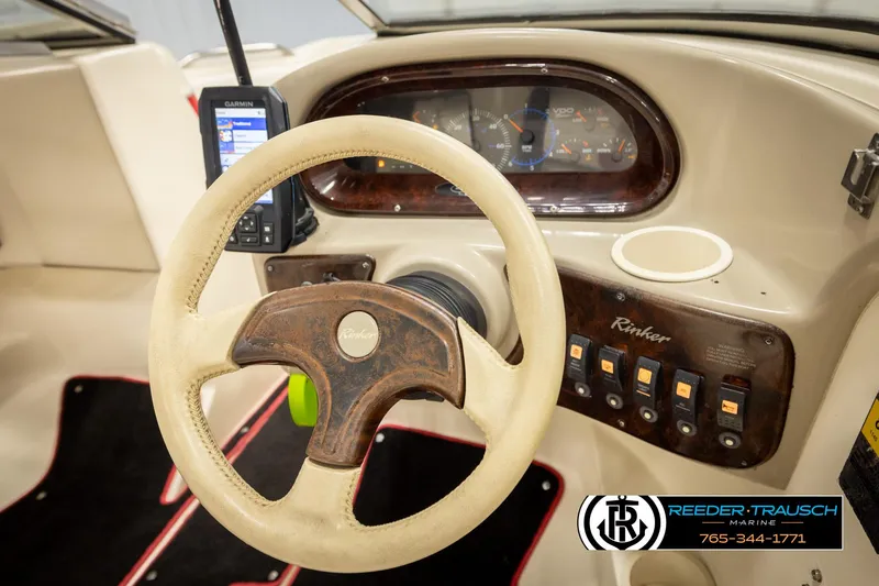 Slide: The Image of 2002 Rinker 192 Captiva boat dashboard with steering wheel and control panel. - 30