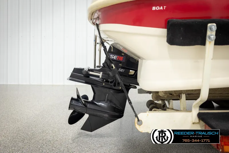 Slide: The Image of 2002 Rinker 192 Captiva boat stern with outboard motor in a showroom. - 49