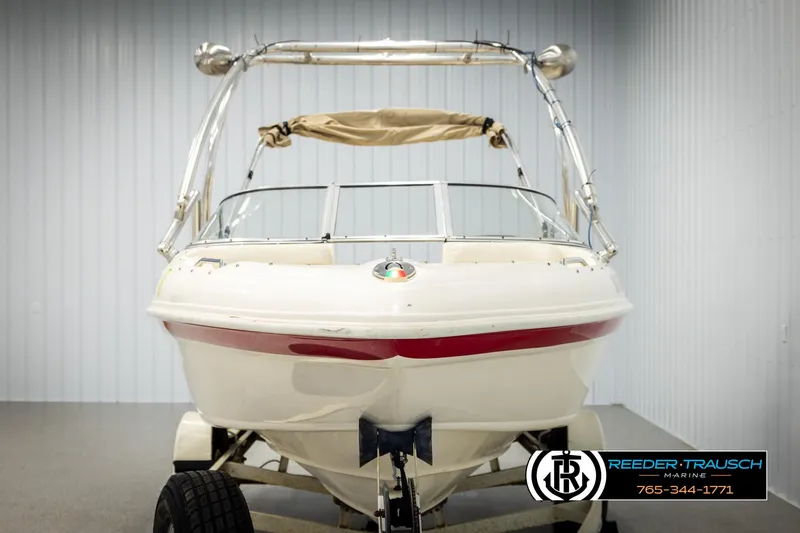 Slide: The Image of 2002 Rinker 192 Captiva boat on trailer in indoor showroom. - 8