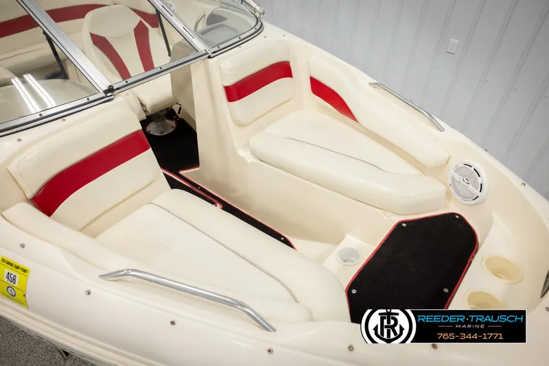Slide: The Image of 2002 Rinker 192 Captiva boat interior with red and white seating, Reeder-Trausch Marine logo. - 9