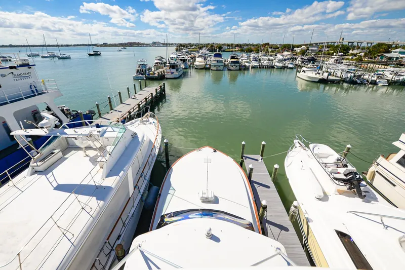 Slide: The Image of Marina view with 1999 Viking 55 Convertible yacht docked among other boats. - 21