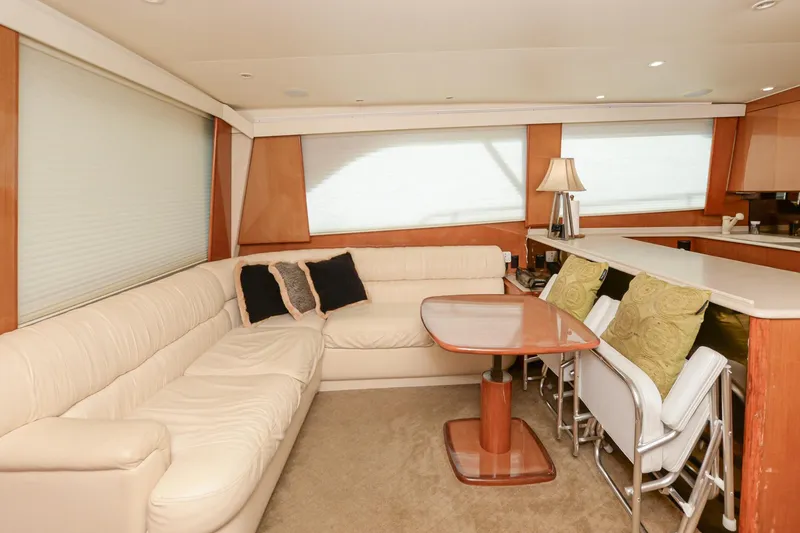 Slide: The Image of Interior of 1999 Viking 55 Convertible yacht with beige seating and dining area. - 35