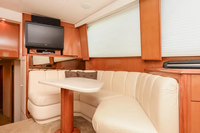 Slide: The Image of Interior of 1999 Viking 55 Convertible yacht with plush seating and TV. - 39