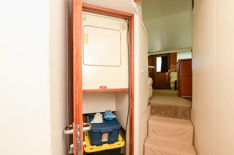 Slide: The Image of Laundry area in 1999 Viking 55 Convertible yacht with storage and stairs. - 45