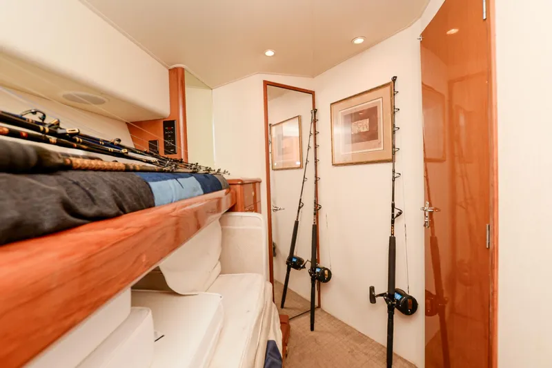 Slide: The Image of Interior of 1999 Viking 55 Convertible yacht with fishing rods and cozy cabin. - 46