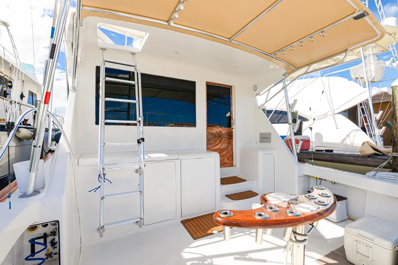 Slide: The Image of 1999 Viking 55 Convertible yacht deck with ladder and fishing rod holders. - 5