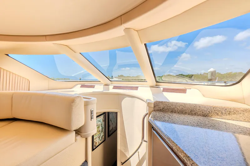 Slide: The Image of Luxurious interior of 2005 Sea Ray 550 Sedan Bridge yacht with panoramic windows. - 15