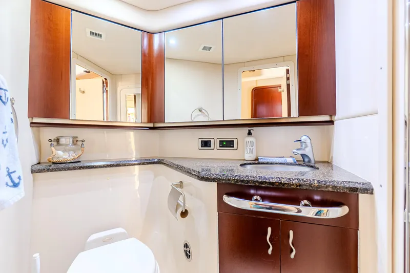 Slide: The Image of Luxurious bathroom in 2005 Sea Ray 550 Sedan Bridge yacht with modern fixtures and wood accents. - 20