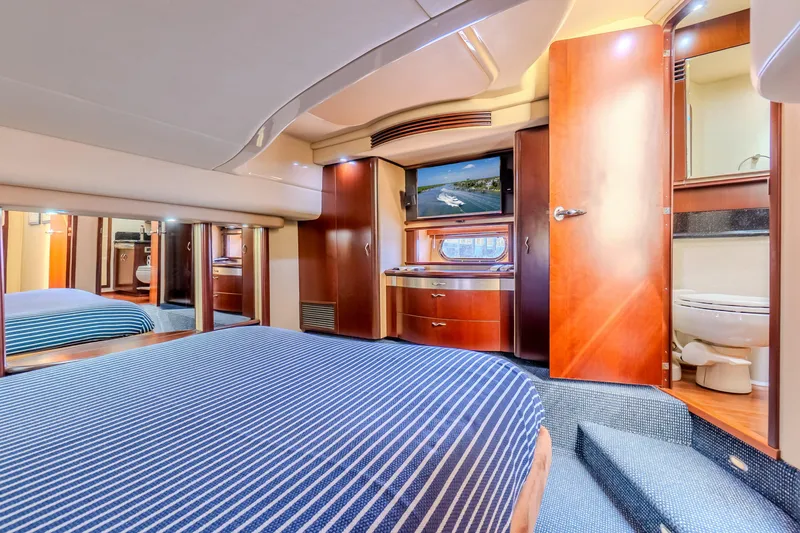 Slide: The Image of Luxurious interior of 2005 Sea Ray 550 Sedan Bridge yacht cabin with wood finishes. - 24