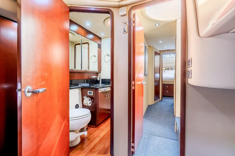 Slide: The Image of Luxurious interior of 2005 Sea Ray 550 Sedan Bridge yacht, featuring bathroom and hallway. - 26