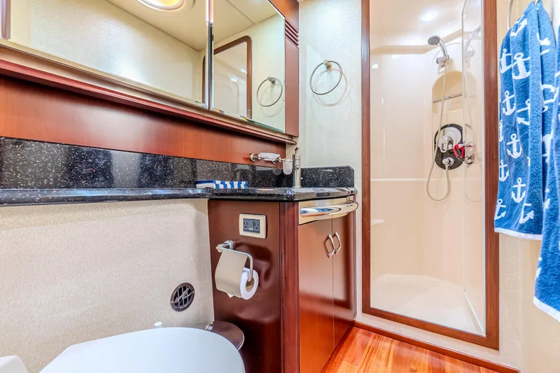 Slide: The Image of Luxurious bathroom in 2005 Sea Ray 550 Sedan Bridge yacht with shower and elegant wood finishes. - 27
