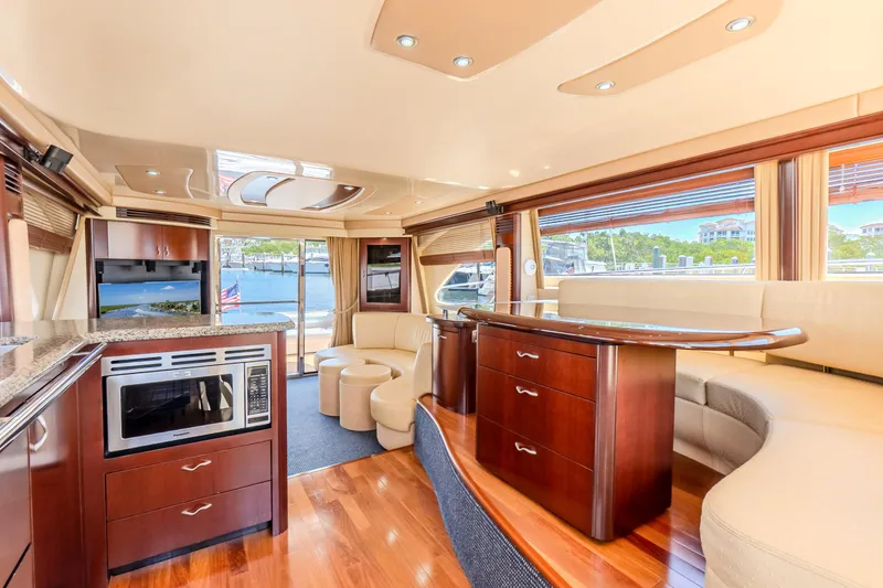 Slide: The Image of Luxurious interior of 2005 Sea Ray 550 Sedan Bridge yacht with elegant wood finishes. - 31