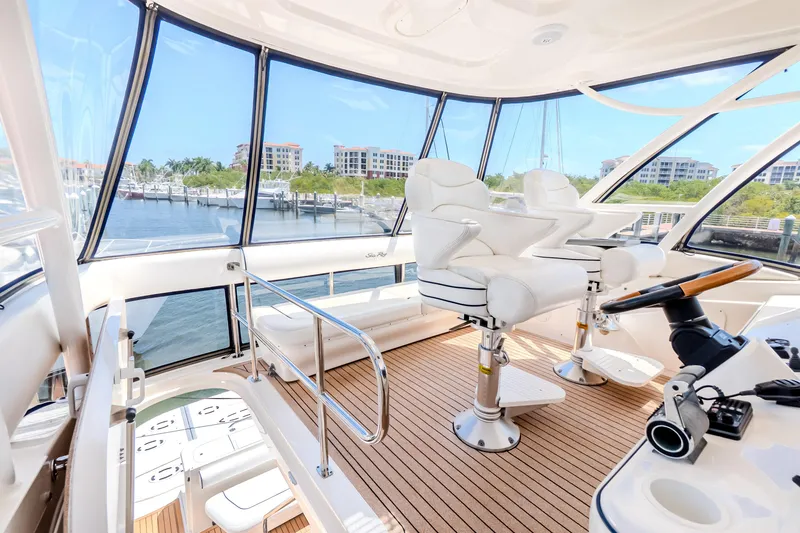 Slide: The Image of Luxurious 2005 Sea Ray 550 Sedan Bridge yacht interior with plush seating and panoramic windows. - 33