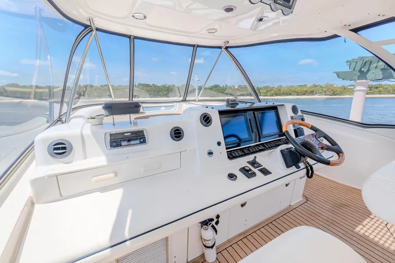Slide: The Image of Helm of 2005 Sea Ray 550 Sedan Bridge with modern controls and scenic water view. - 36