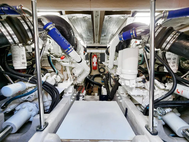 Slide: The Image of Engine room of 2005 Sea Ray 550 Sedan Bridge, showcasing complex machinery and components. - 42