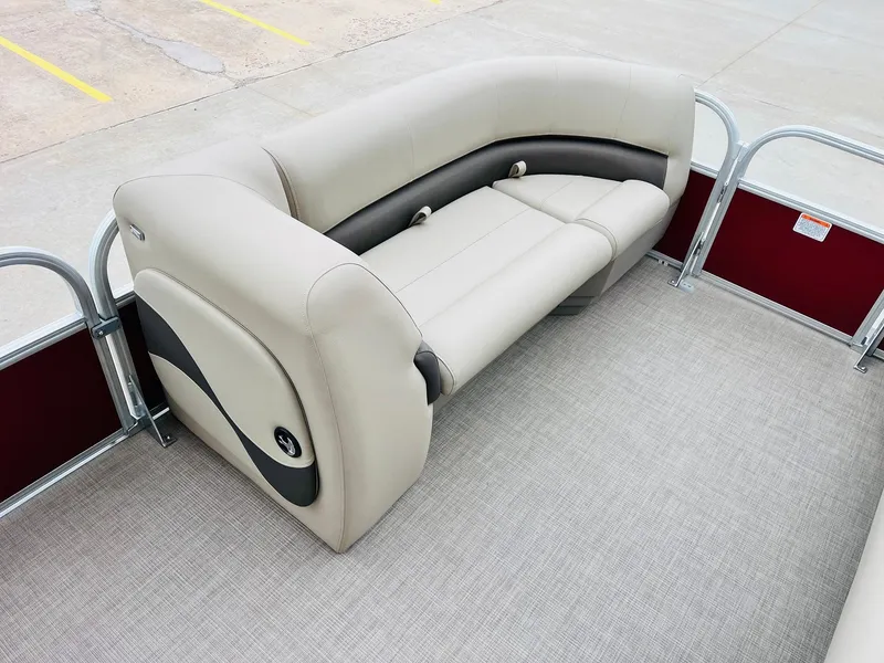 Slide: The Image of 2025 Sun Tracker Party Barge 18 DLX interior with beige seating and red paneling. - 13