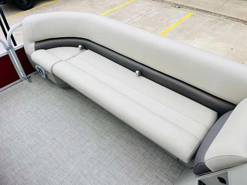Slide: The Image of 2025 Sun Tracker Party Barge 18 DLX pontoon boat seating, featuring comfortable beige upholstery. - 19
