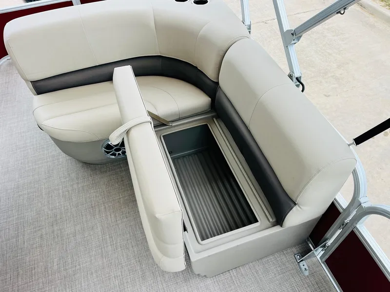 Slide: The Image of 2025 Sun Tracker Party Barge 18 DLX seating with storage compartment open. - 25