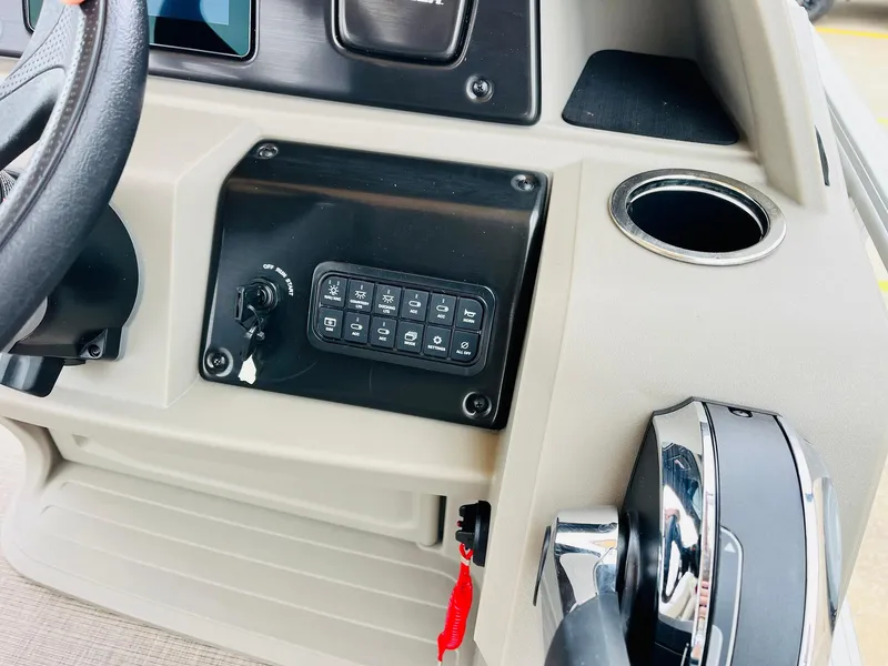 Slide: The Image of Control panel of 2025 Sun Tracker Party Barge 18 DLX with steering wheel and cup holder. - 31