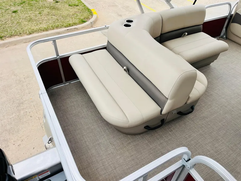 Slide: The Image of 2025 Sun Tracker Party Barge 18 DLX with beige seating and cup holders on deck. - 35